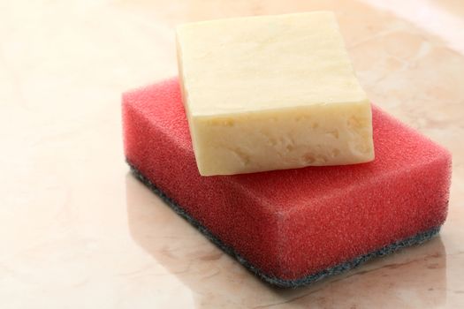 Bar of soap and sponge on tile