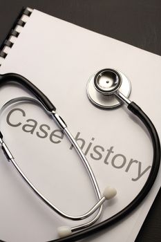 Case history and stethoscope on black