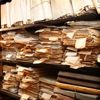 Paper documents stacked in archive