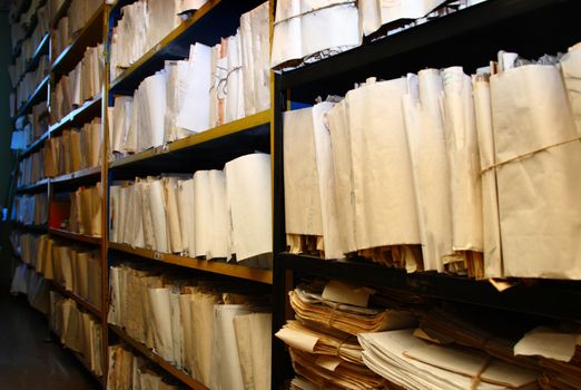 Paper documents stacked in archive