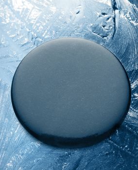 Black round label on frozen background