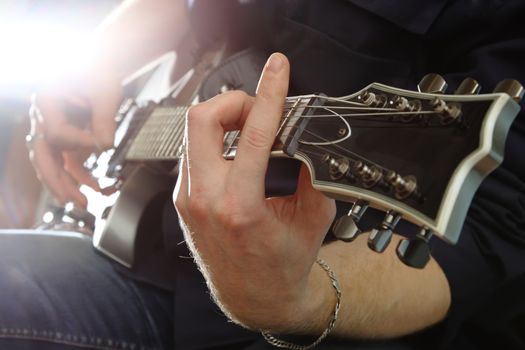 Electric guitar in male hands