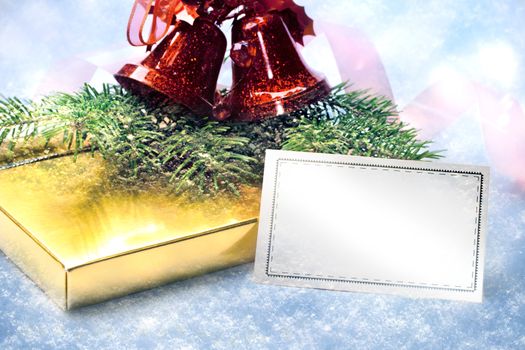 Christmas decoration with gift and card on white snow