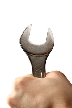 Metallic wrench in male hand