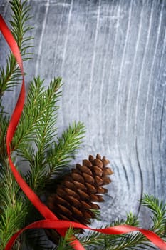 Christmas decoration with fir and cone on wooden background