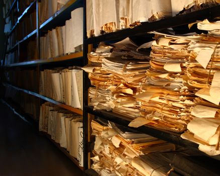 Paper documents stacked in archive