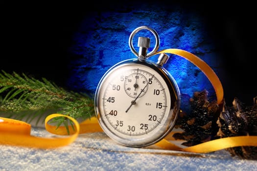 Stopwatch and christmas decoration on black