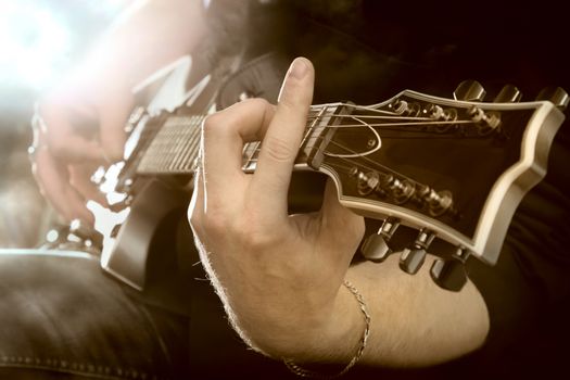 Electric guitar in male hands