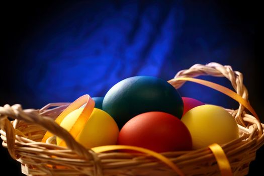 Easter eggs with yellow ribbon in basket