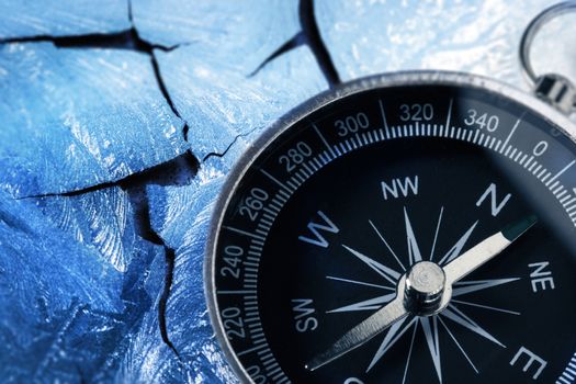 Compass on racked piece of old wall in icy style