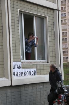 Khimki, Moscow region, Russia - October 14, 2012. Coordinator of Staff oppositionist Chirikova Olga Pakhtusova removes what is happening on the street. The headquarters of the candidate for mayor of the city of Khimki opposition leader Yevgeniya Chirikova. On election day in the suburban town of Khimki broke sharp competition between the candidate of the Kremlin Oleg Shahov and representative opposition Yevgenia Chirikova.