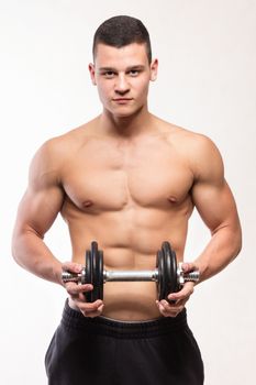 Muscular fitness man holding dumbbell - studio shoot 