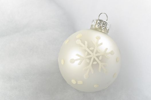Christmas Bauble on snow white background