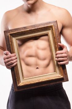 Muscular man with six-pack and frame on his torso - studio shoot