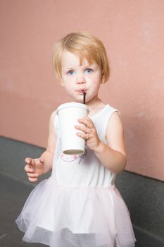 Healthy kid, milk - Portrait of lovely girl drinking fresh milk outdoors