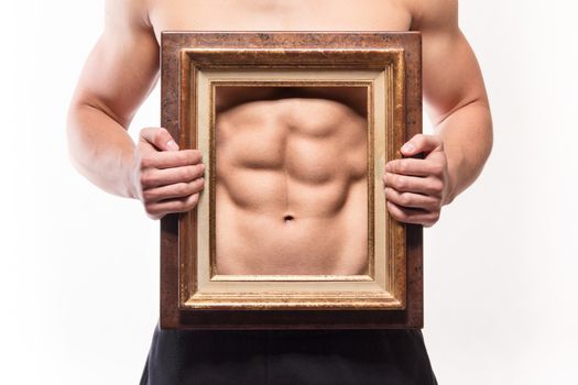 Muscular man with six-pack and frame on his torso - studio shoot