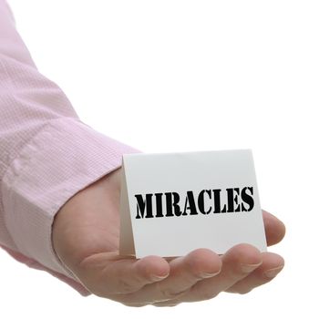Business man holding miracles sign on hand 