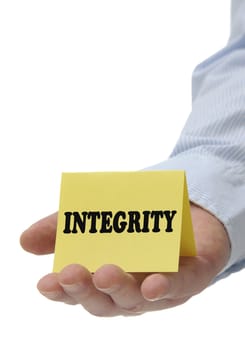 Business man holding yellow integrity sign on hand 