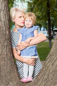 Young mother and her toddler girl have fun