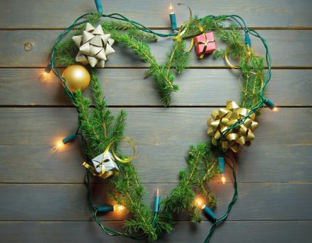 Christmas tree fir in the shape of a heart with lights and decorations