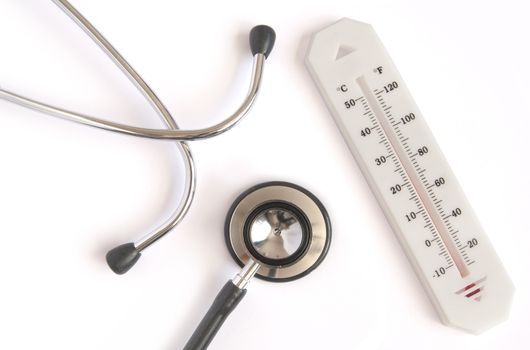 Medical stethoscope and thermometer over a white background