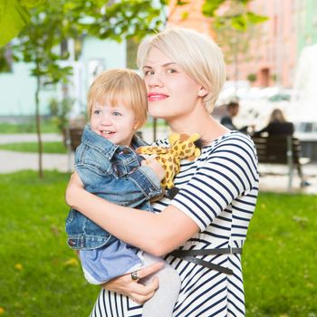 Young mother and her toddler girl have fun