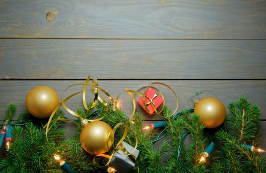 Christmas decorations over a wooden background with tree branches and lights 
