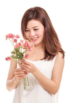 Beautiful Chinese woman with pink flowers in a vase