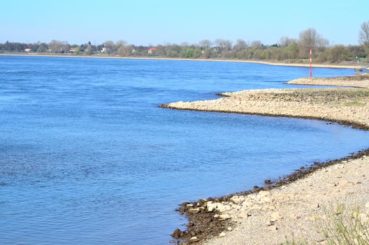 The Rhine near Dusseldorf Kaiserwerth in his blue bed surrounded by a picturesque riverside landscape
