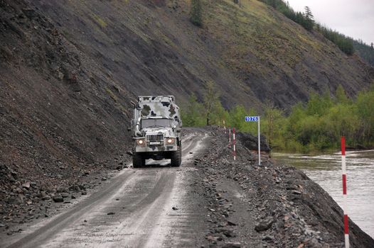 Truck at gravel road Kolyma highway outback Russia, Magadan and Yakutia region