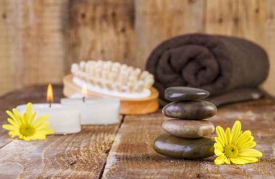 zen basalt stones and spa oil with candles on the wood