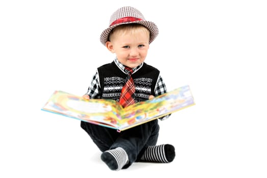 Smiling happy boy in hat and tie shot in the studio on a white background