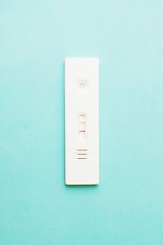 photo of Positive pregnancy test on green background.