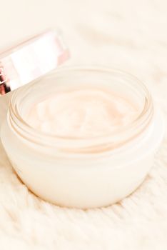 Cosmetic cream in an open jar with shallow depth of field