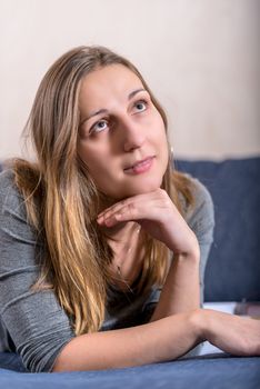 Close up face portrait of young brunette woman looking up