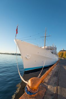 Mooring rope and white ship on sky background