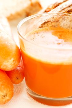 Carrot juice, carrots and carrot bread close up