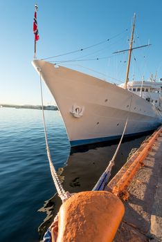 Mooring rope and white ship on sky background