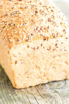 Composition with loaf of bread on wooden table