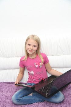 Young Girl Using Laptop At Home