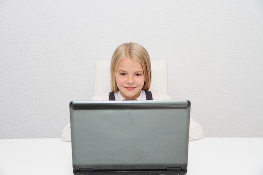 Young Girl Using Laptop At Home