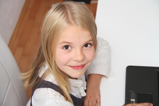 Young Girl Using Laptop At Home