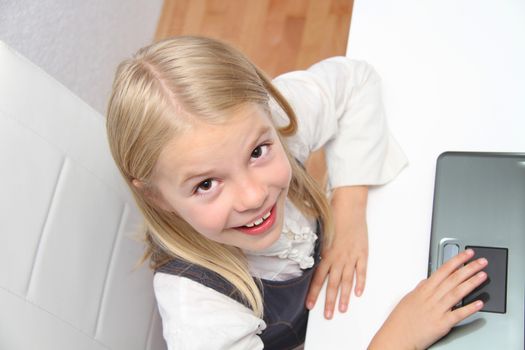 Young Girl Using Laptop At Home