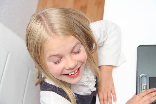 Young Girl Using Laptop At Home