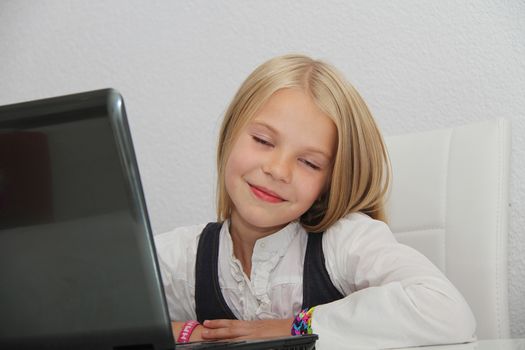 Young Girl Using Laptop At Home