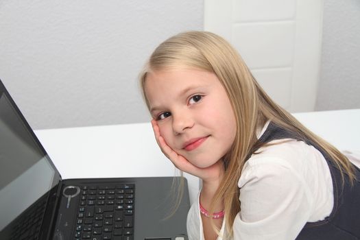 Young Girl Using Laptop At Home