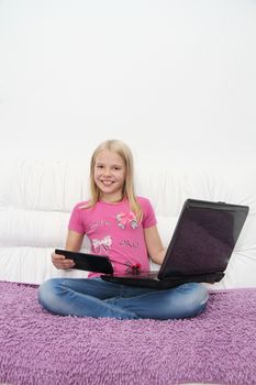 Young Girl Using Laptop At Home