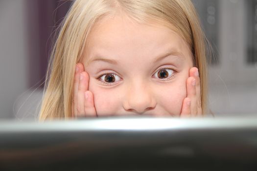 Young Girl Using Laptop At Home