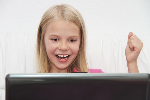 Young Girl Using Laptop At Home