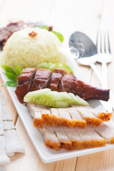Chinese roasted pork belly served with soy and seafood sauce. Malaysian cuisine. Fresh cooked with hot steam and smoke.
